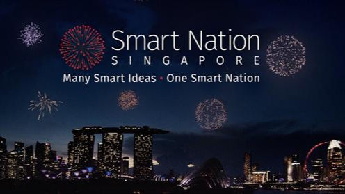 Night skyline of Singapore with fireworks. Text: "Smart Nation Singapore. Many Smart Ideas • One Smart Nation." Celebratory mood.