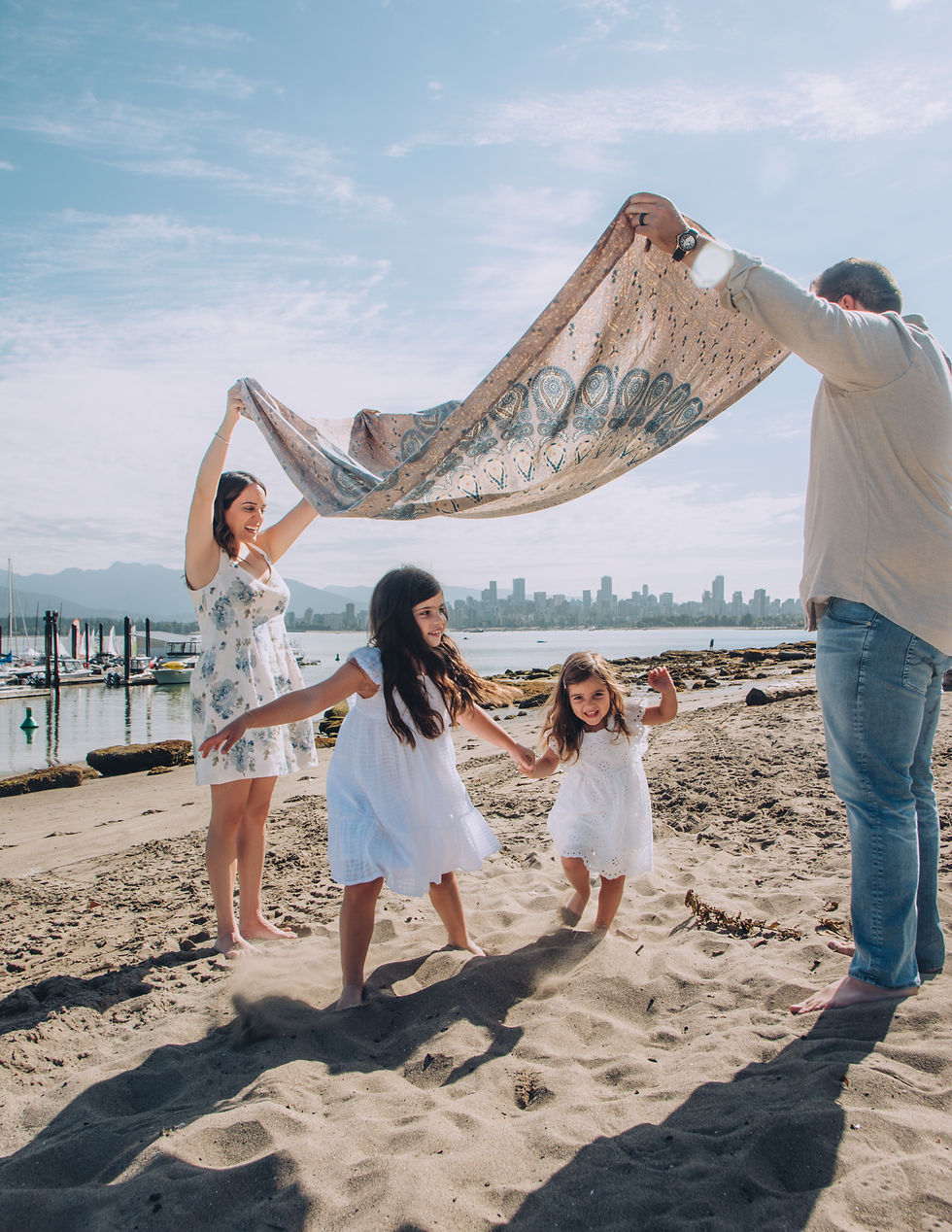 Family on vacation in Vancouver laughing together during candid photo session outdoors