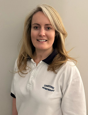 Physiotherapist Hannah Hopgood smiling, wearing professional attire, ready to assist with mobile physiotherapy.