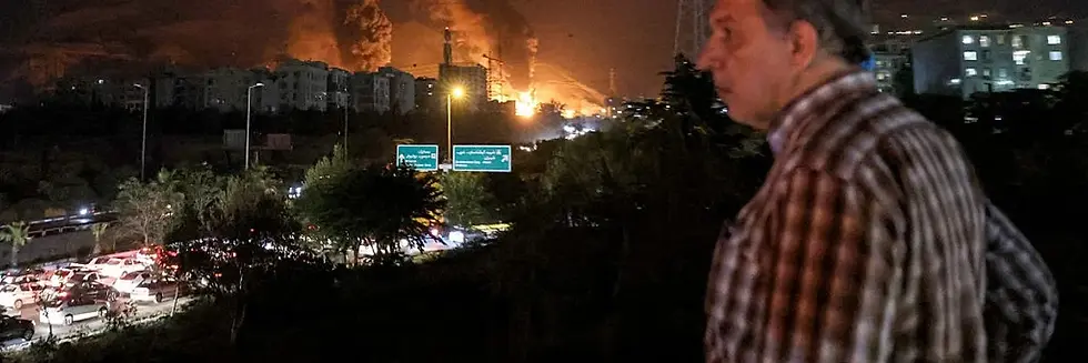 A man watches near a highway blocked with traffic amid Israeli attacks in Shahran, northwest of Tehran, on June 15, 2025. (Photo: Atta Kenare/AFP via Getty Images)
