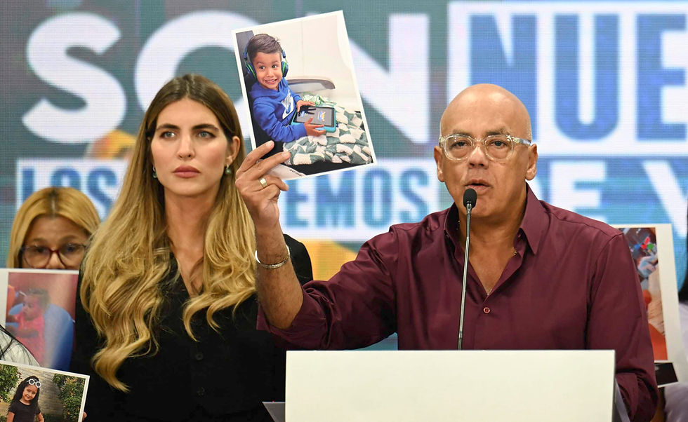Venezuela’s National Assembly President Jorge Rodriguez shows a photo of one of the children who remains in the US after being separated from his parents during a press conference in Caracas on June 30, 2025. The Venezuelan government accused the United States of “kidnapping” 18 children after separating them from their parents during deportation proceedings carried out by Washington to expel migrants from that country. (Photo by Juan BARRETO / AFP)