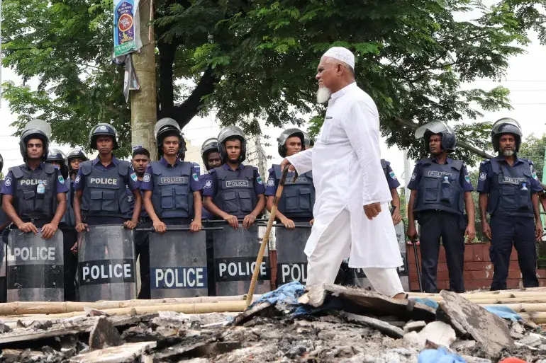 A man walks past a police cordon a day after violent clashes erupted between supporters of ousted Prime Minister Sheikh Hasina and security forces, in Gopalganj, Bangladesh, on July 17, 2025 [Abdul Goni/AP]
