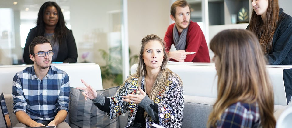 Image of a workplace with people discussing