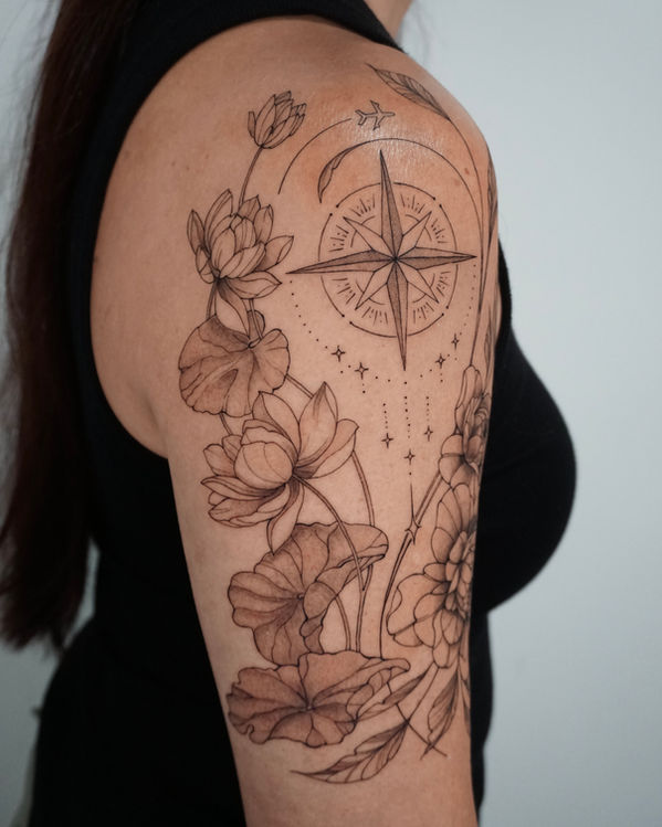 Floral compass arm tattoo by female tattoo artist at Kapwa Tattoo Studio Oahu