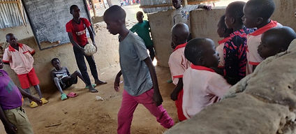 Children practicing kicking a ball.