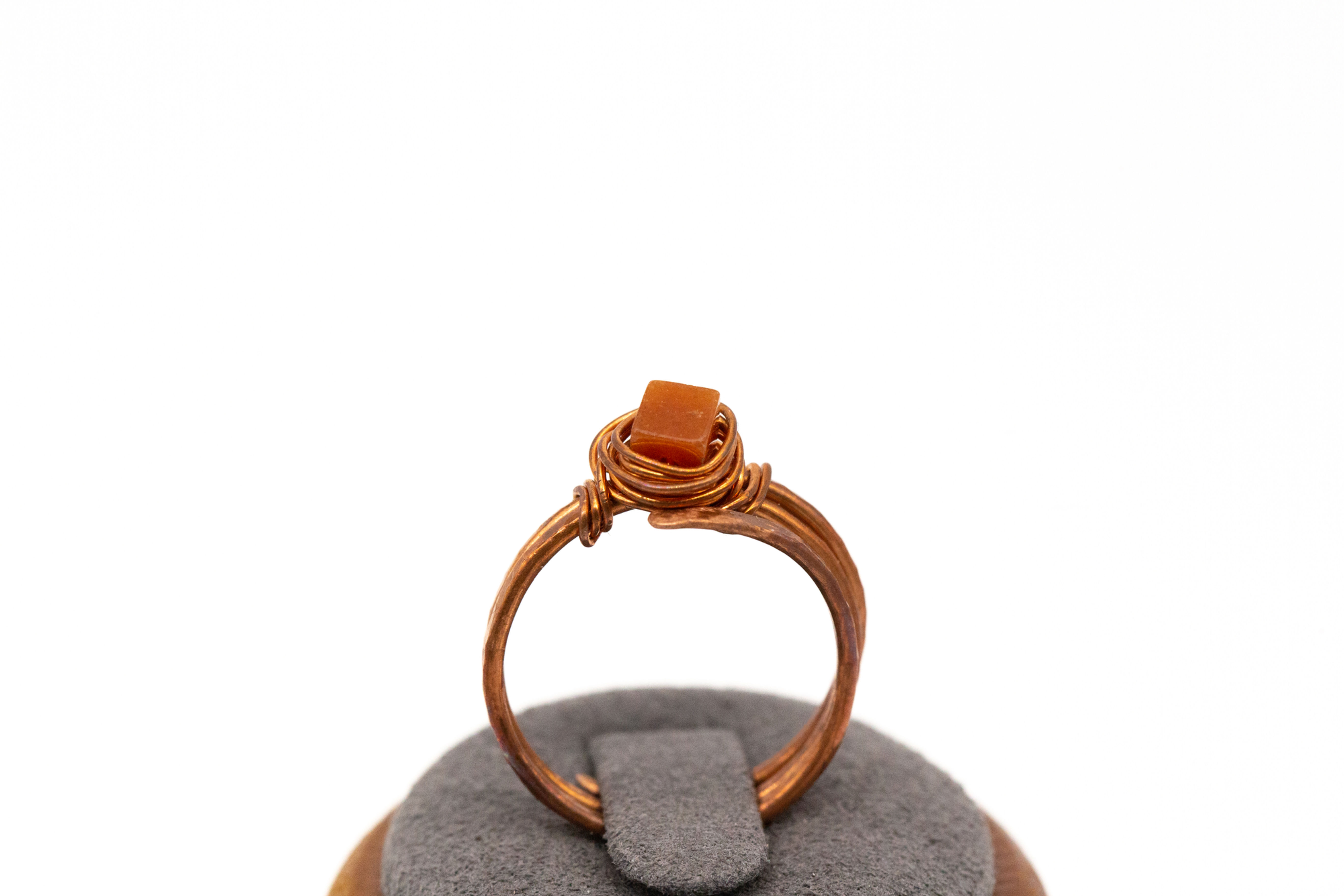 Burnt orange carnelian birds’ nest ring in hammered copper.