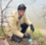 Nicci applying herbicide to a honeysuckle stump alongside the Kaw River, March 2024