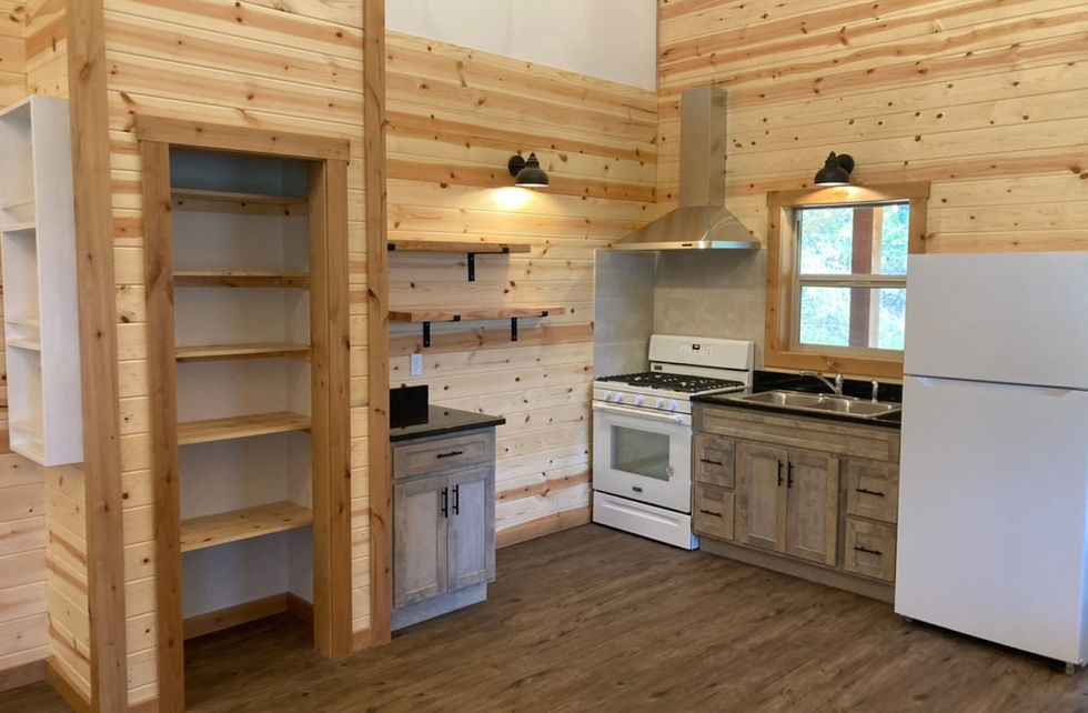 wood kitchen with open shelving and white refrigerator