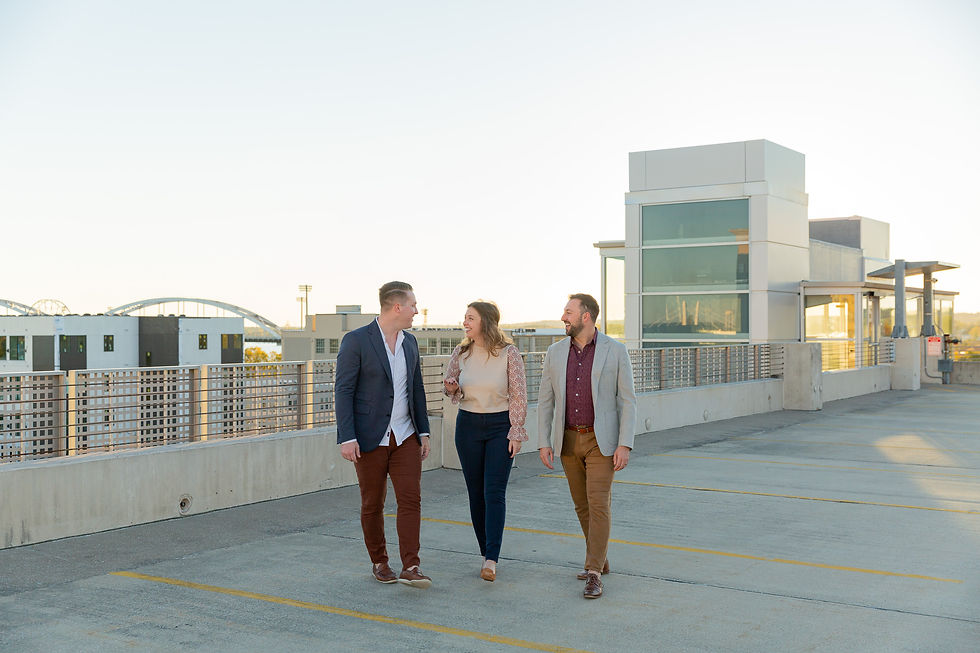 The BKP Team—Hannah Thomsen, Brandon Kane, and Forest Kane—embracing on a rooftop in Davenport, Iowa. Photographed by Brandon Kane Photography, premier Davenport wedding photographers specializing in capturing authentic, heartfelt moments.
