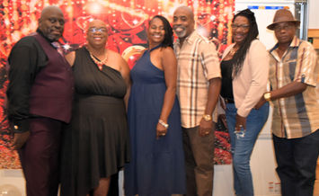Group portrait of six elegantly dressed adults at a festive event