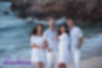 Family of four posed on beach