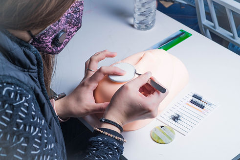 female-hand-putting-false-eyelashes-on-a-mannequin-2025-02-03-07-44-16-utc.jpg
