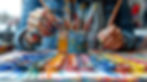 Hands of artist mixing colorful paints
