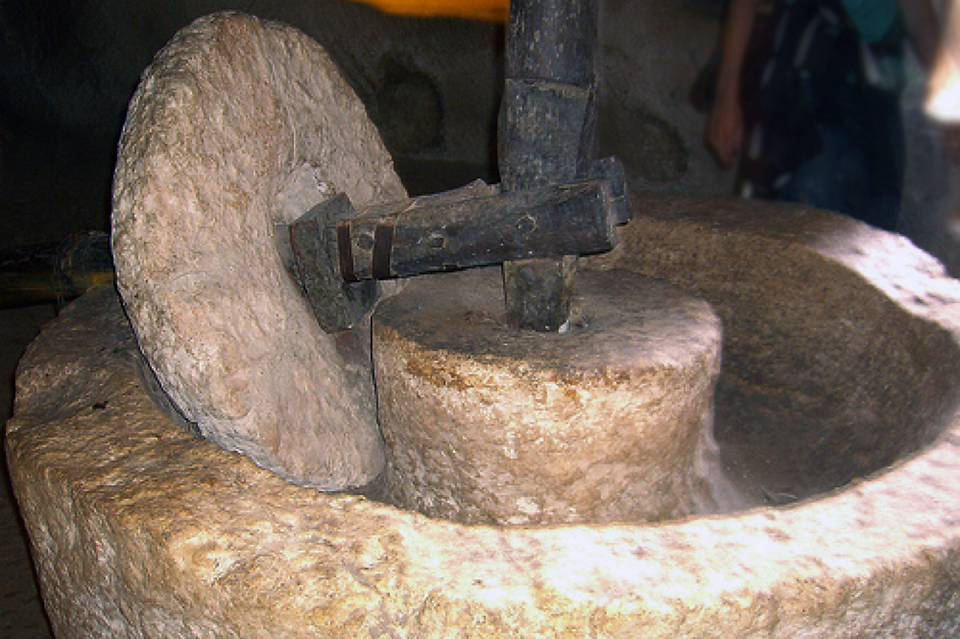 old-style olive oil grind wheel press