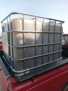 1,000L bulk evoo IBC pallet on pick-up truck for delivery.