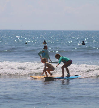 Small group surf lesson in the water at Jacó beach, Costa Rica