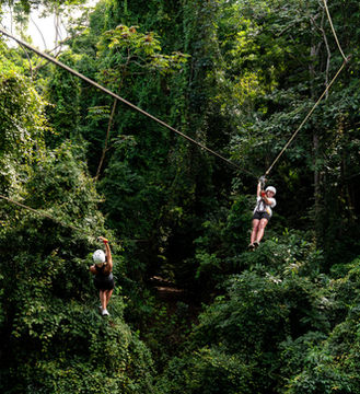 Canopy zipline experience above tropical rainforest in Jacó Costa Rica