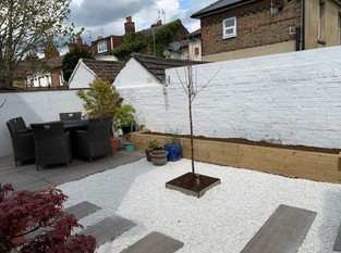 Garden makover featuring patio, raised bed, planting and ground cover