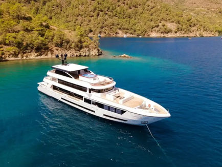 Luxury motor yacht cruising along the Bodrum coastline