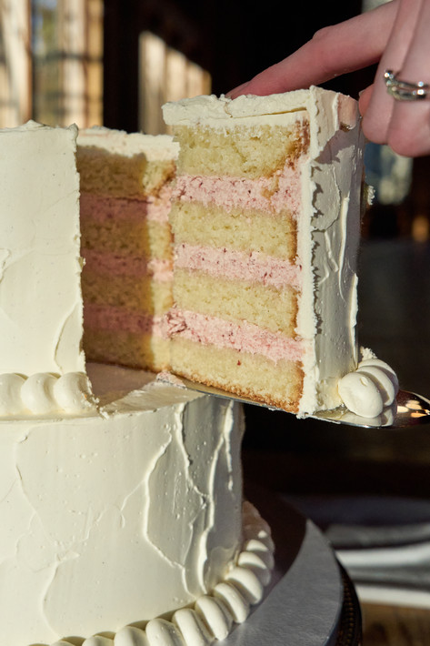 Luxury white two-tiered wedding cake with textured finish and bead border piping at Bilston Creek Farm