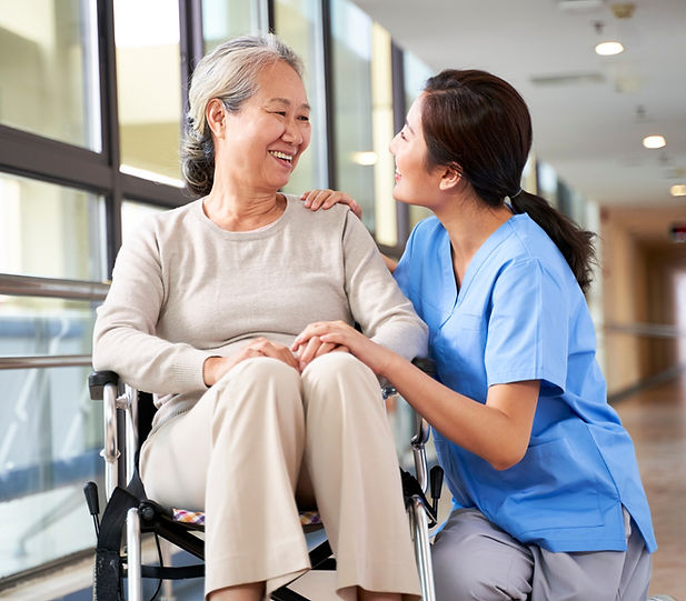 Doctor smiling at patient in a wheelchaire