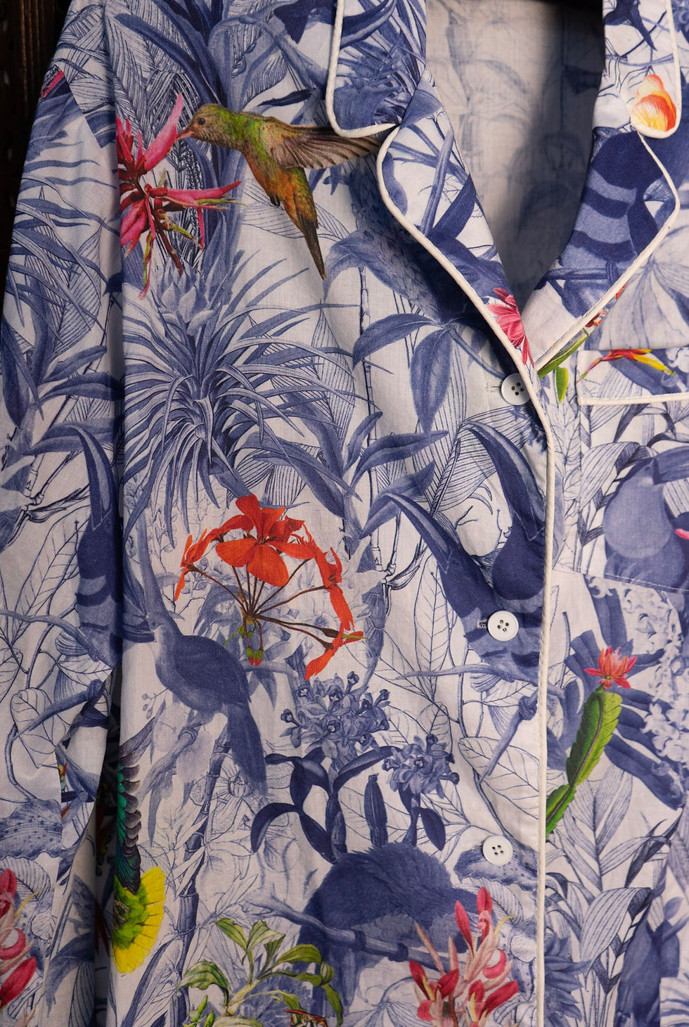 Thumbnail: Close-up of tropical cotton pajama top, showing colorful botanical print and white buttons.