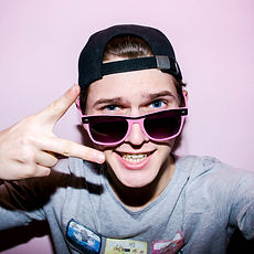 Attractive emotional young man with glasses in studio.jpg