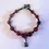 Thumbnail: Fine bracelet, ceramic beads and cello charm, amber and black color
