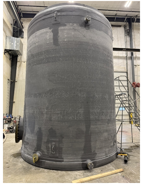 Figure 3: FRP tank being subjected to final inspection before shipment in accordance with ASME RTP-1, This FRP vessel is being visually inspected and acoustic emission tested before it is packed onto a truck and shipped to its destination for quality control purposes.