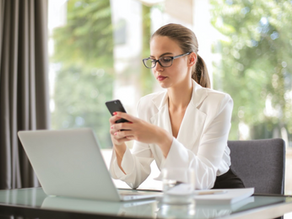 women with glasses looking at phone