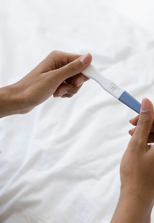 woman holding pregnancy test