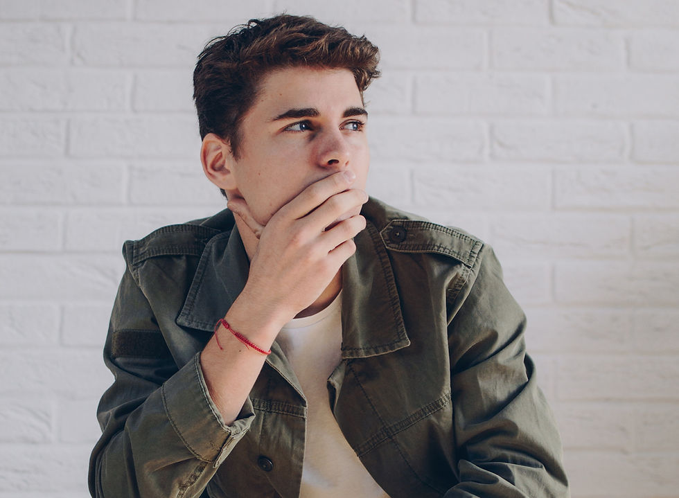 man covering mouth thinking