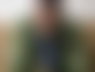 African American man in green jacket looking concerned