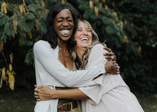 two women hugging and smiling
