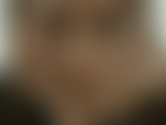 A woman standing alone in her kitchen, reflecting on her experience with an at-home abortion and the silence that followed