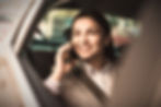 smiley-businesswoman-talking-phone-while-car_edited.jpg