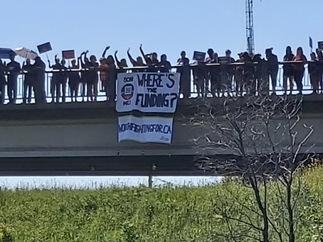 We won’t be ignored: striking community, health and social services workers drop banners from bridges and highway overpasses across Ontario