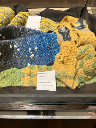 Yellow and green scarf with felted Australian magpie embellishments on display