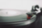 A vinyl record spinning on a turntable, representing timeless music choices for funerals and memorial tributes.