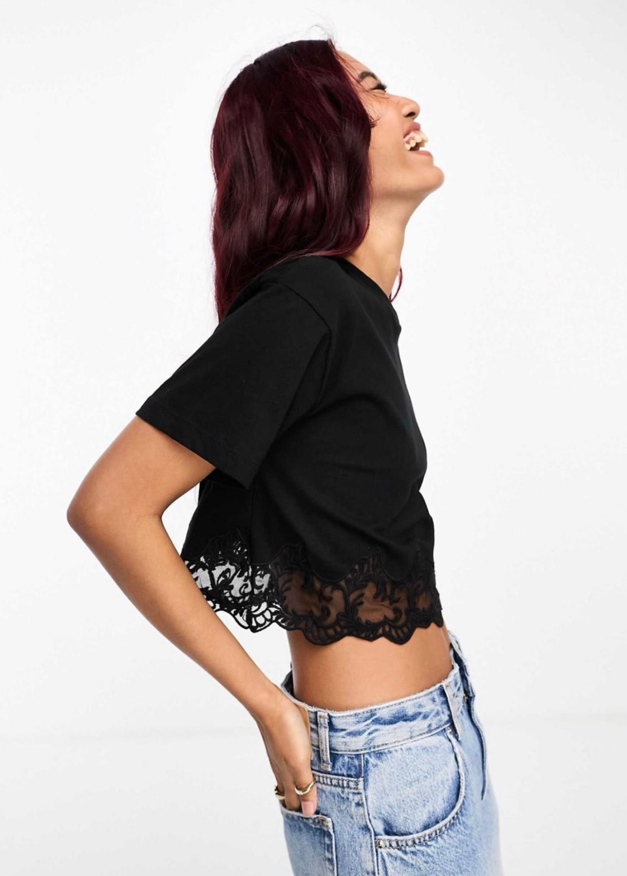 Woman in black lace crop top, laughing
