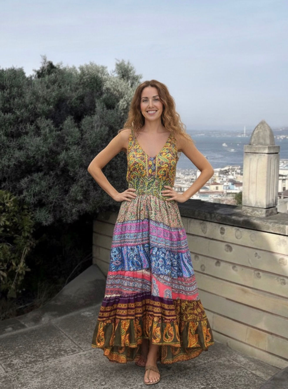 Smiling woman in vibrant patterned maxi dress