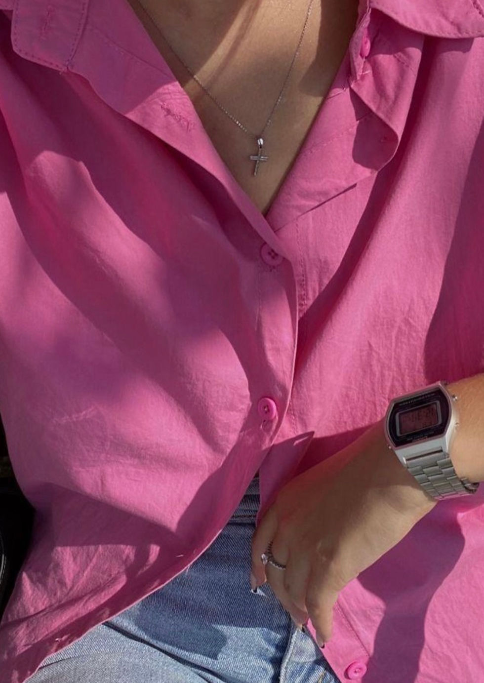 Thumbnail: Pink shirt, silver necklace, digital watch, and ring on hand