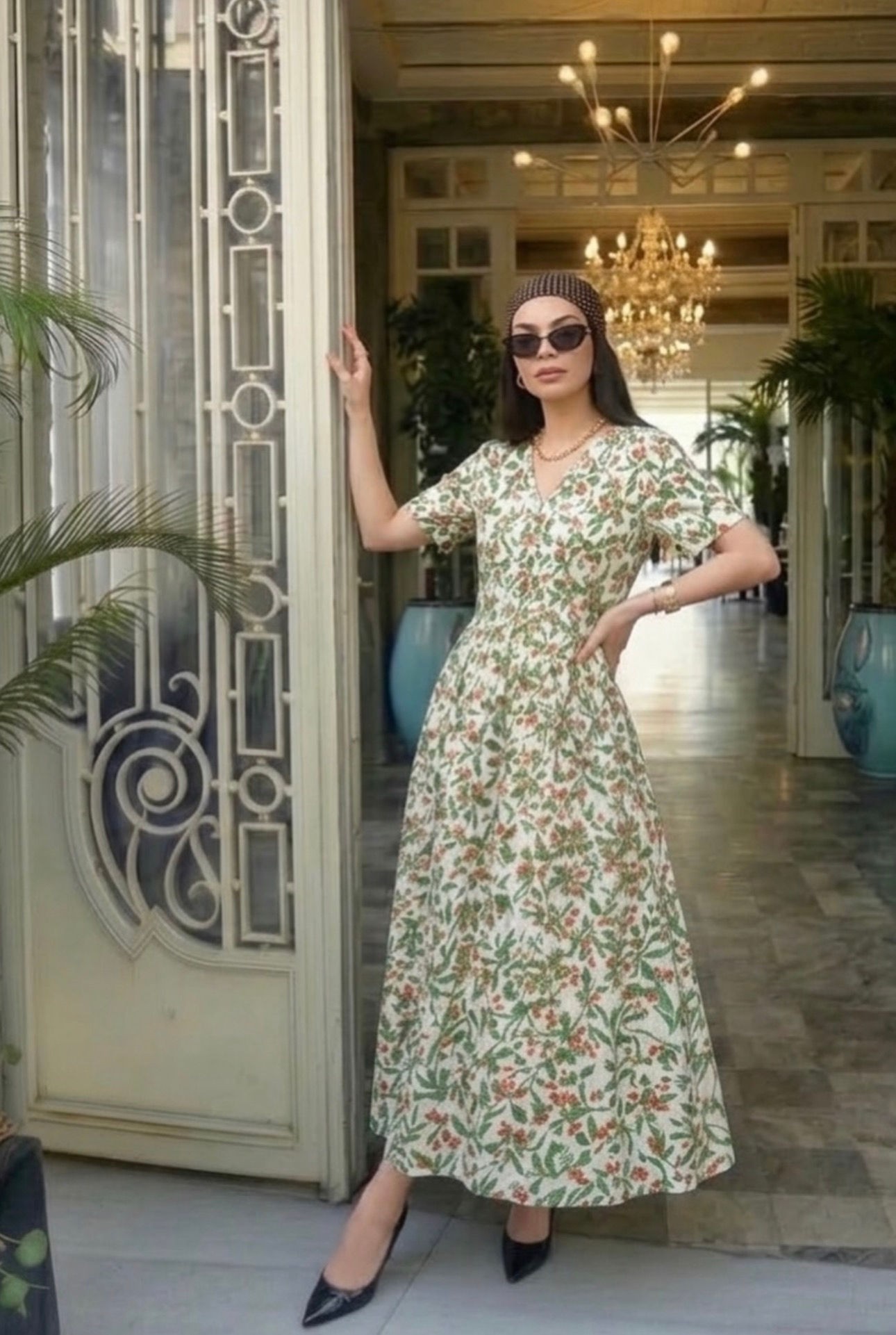 Woman in patterned maxi dress and sunglasses