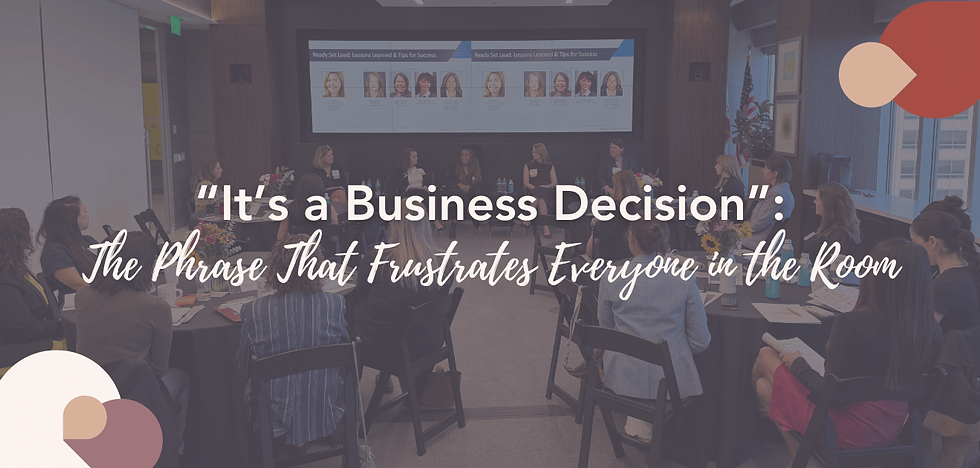 Room of women listening to a panel of female speakers.