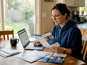 Woman comparing vision insurance at kitchen table
