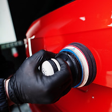 car-detailing-concept-hands-man-with-orbital-polisher-repair-shop-polishing-orange-suv-car