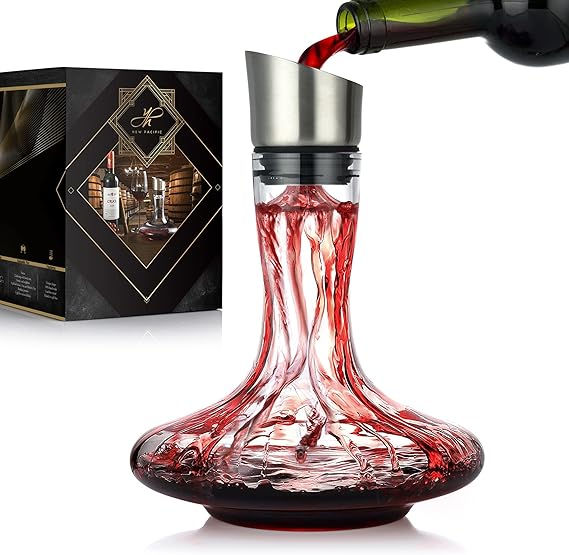 Wine pouring into a clear decanter with a silver spout, set against a decorative box background. The wine swirls in vibrant red patterns.