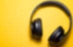 A pair of headphones on a yellow background