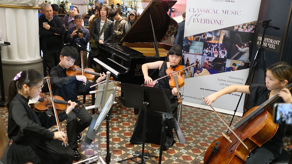 A string quartet performs beside a grand piano as an audience watches; banner reads Classical Music for Everyone.