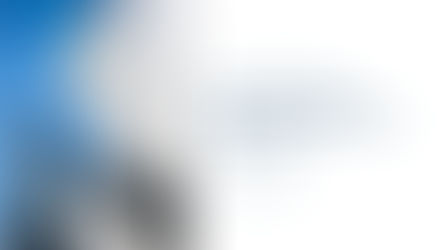 A lone figure stands on sweeping architectural steps between towering glass skyscrapers against a bright blue sky, alongside the title 'The Reality Gap: Why Your Team Dreads the New System' published by Dimensional Community in The SimCorp Review